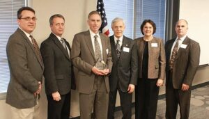 ISSITS team members receive the 2010 Small Business of the Year award.